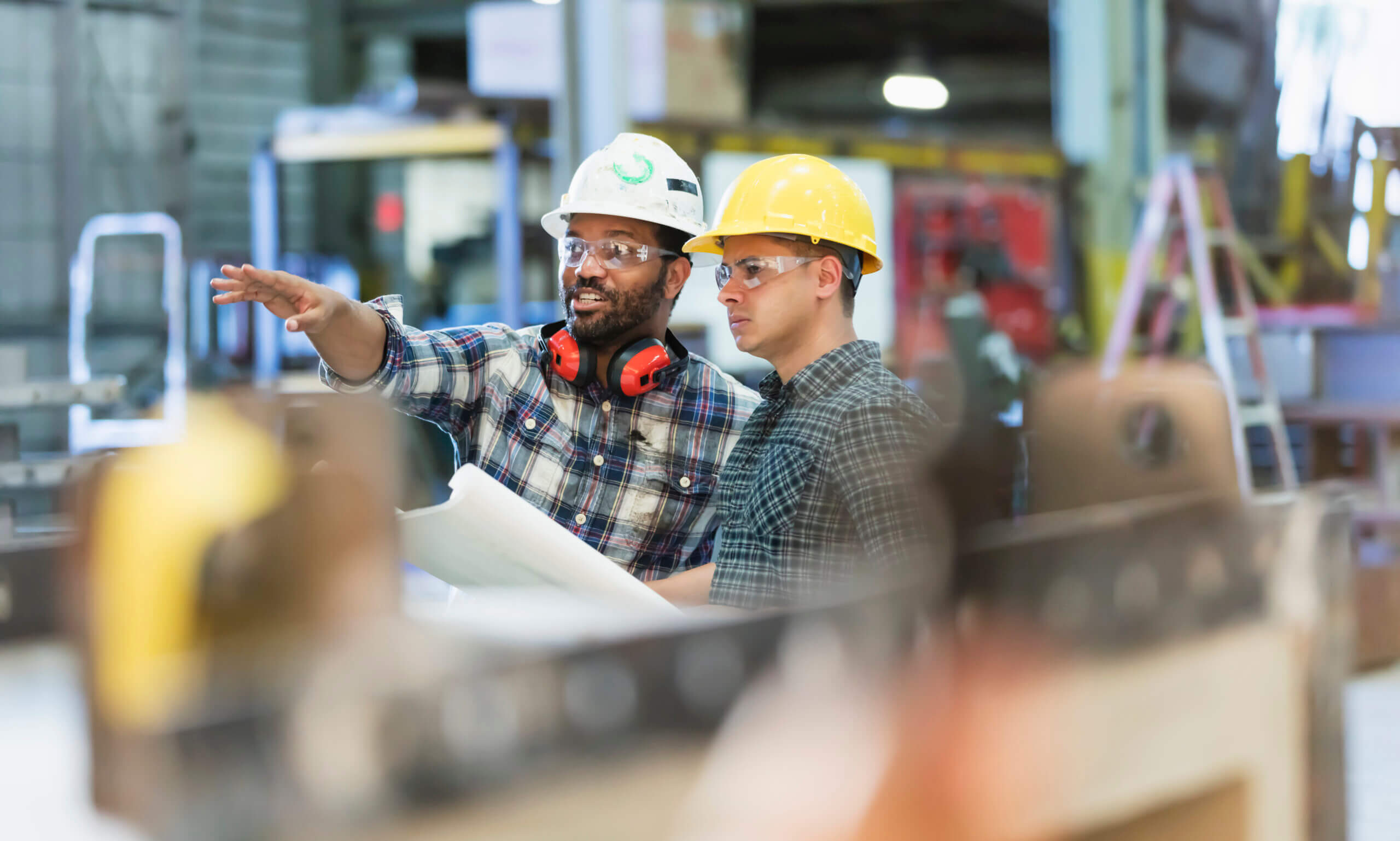 Multi Ethnic Workers Talking In Metal Fabrication Plant